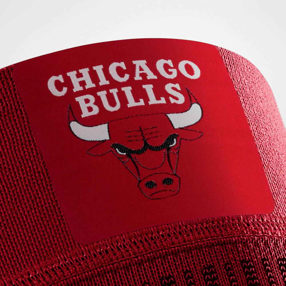 Close-up of Chicago Bulls logo on the front of Bauerfeind's Sports Compression Knee Support NBA Bulls Edition.