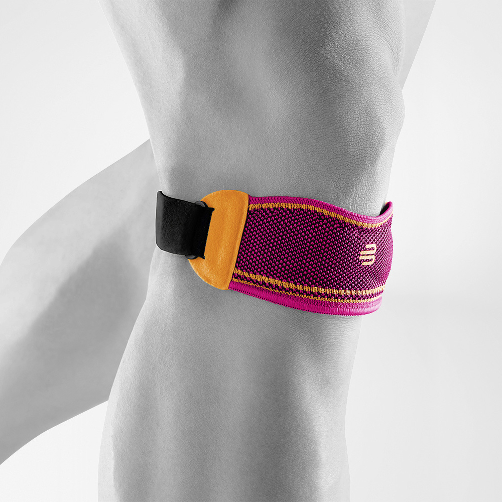 Close-up of a person wearing a blue and green knee strap for pain relief during sports