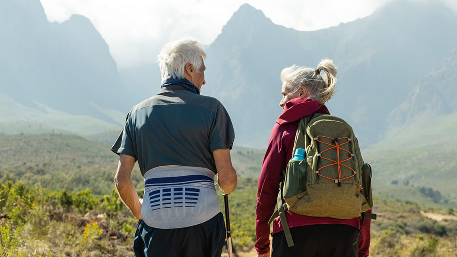 Senior man wearing the LumboLoc while hiking with a senior woman. Senior man wearing Bauerfeind's LumboLoc back brace while hiking with a senior woman.