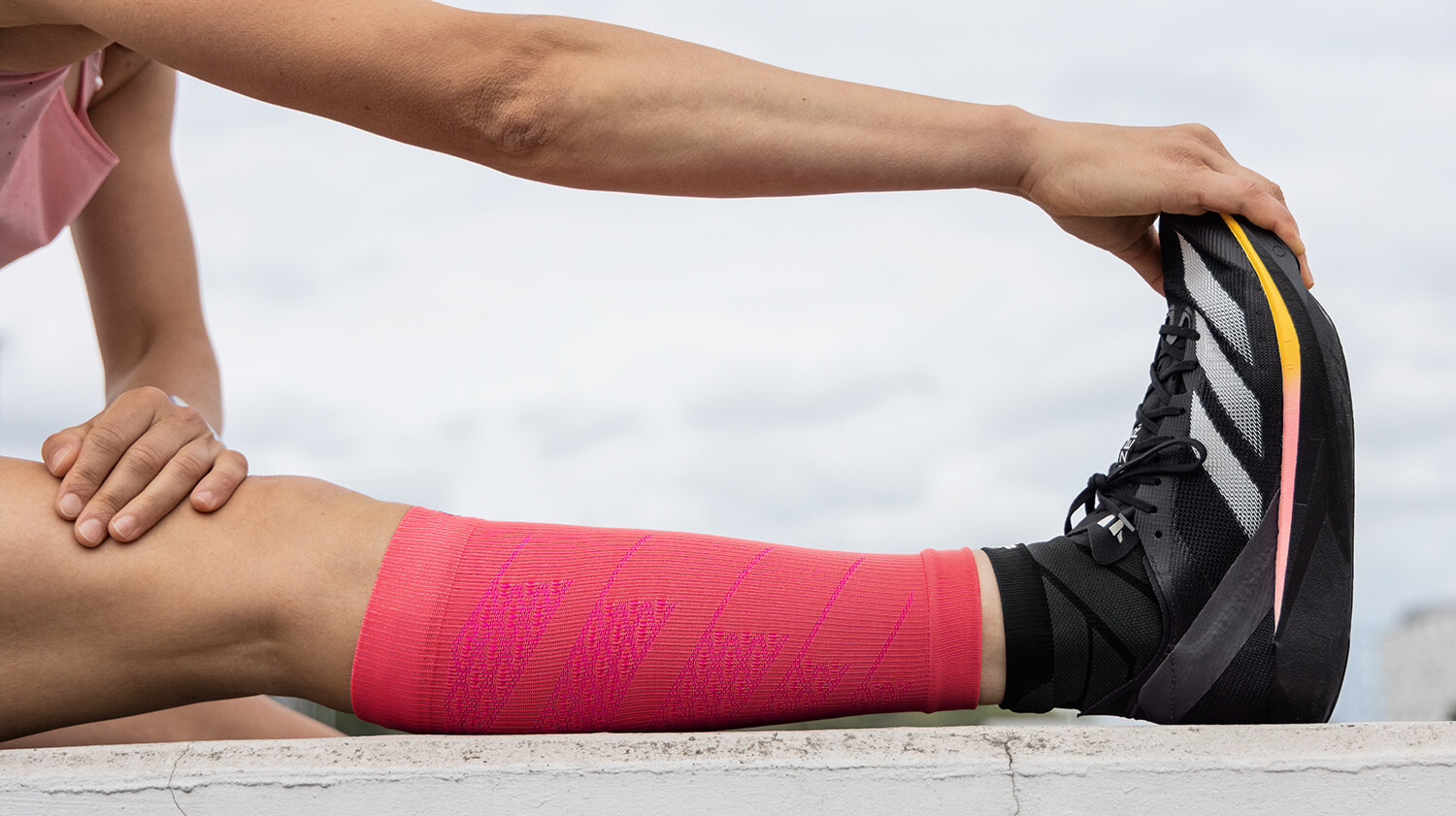 Runners wearing Run Performance Sleeves stretching