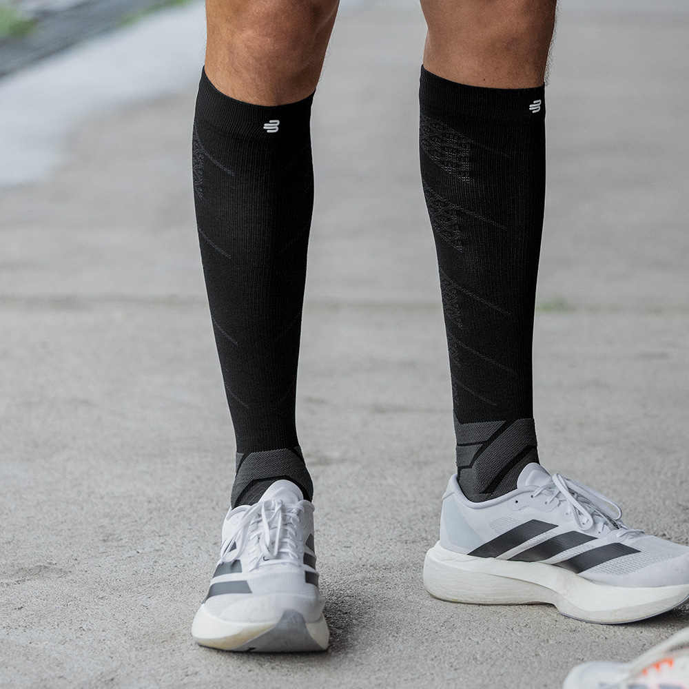 Athlete wearing Bauerfeind's black Run Performance Compression Socks.