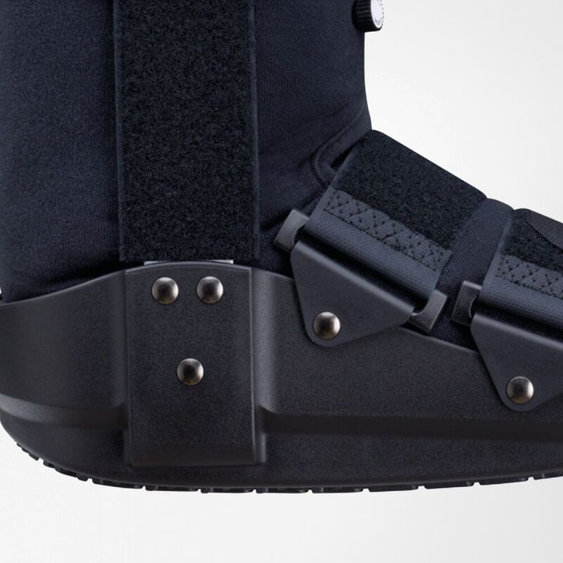 Buy Orthopedic Walking Boot Online | Adjustable, Reinforced Sole Navy blue orthopedic walking boot with adjustable straps and reinforced sole on a white background.