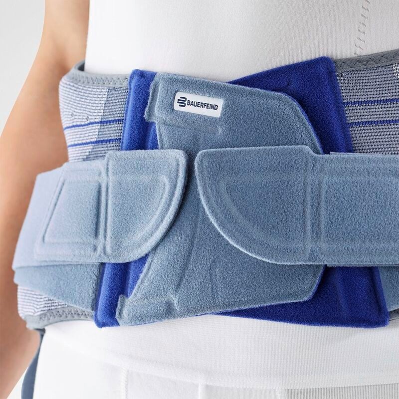 Close-up view of a high-quality Bauerfeind lumbar support brace worn by a person, showing detailed texture and logo.