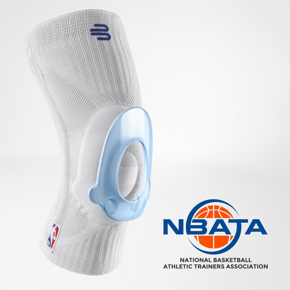 Black knee brace for athletic support with NBA logo. Close-up of a person wearing a black knee brace with an NBA logo for support during sports activities.