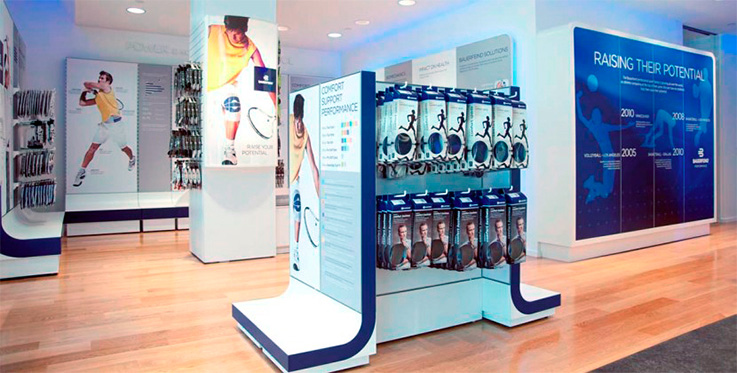 Sports Brand Retail Store Design Featuring Athletic Gear and Brand Milestones Modern sports retail store interior with promotional displays for athletic gear and history timeline of a sports brand.
