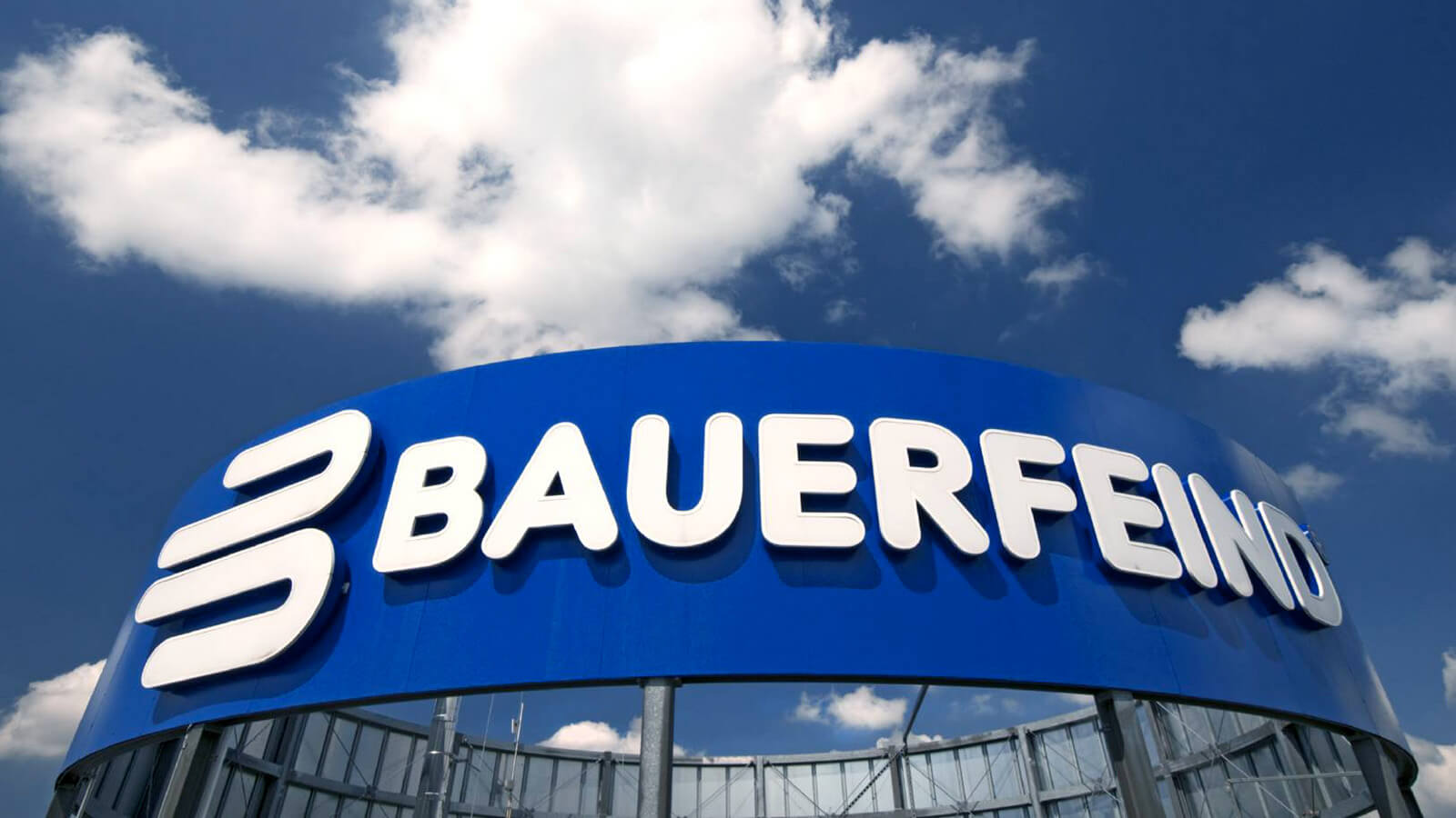 Bauerfeind Headquarters in Germany Bauerfeind signage located atop its main company headquarters in Germany, with a clouded sky in the background.