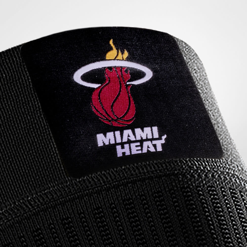 Close-up of Miami Heat logo on black fabric background.