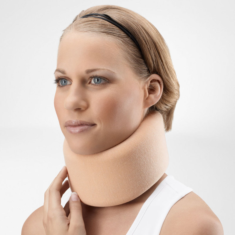 Woman wearing a beige neck brace for cervical support