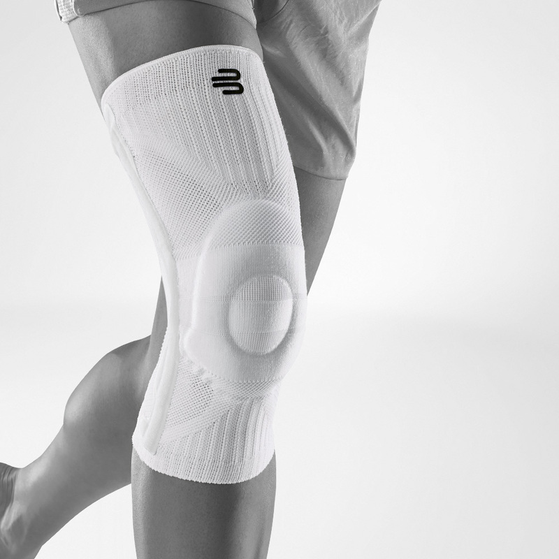 Enjoy the Outdoors with Sports Knee Support Woman jogging in the forest with a knee brace, wearing athletic gear.