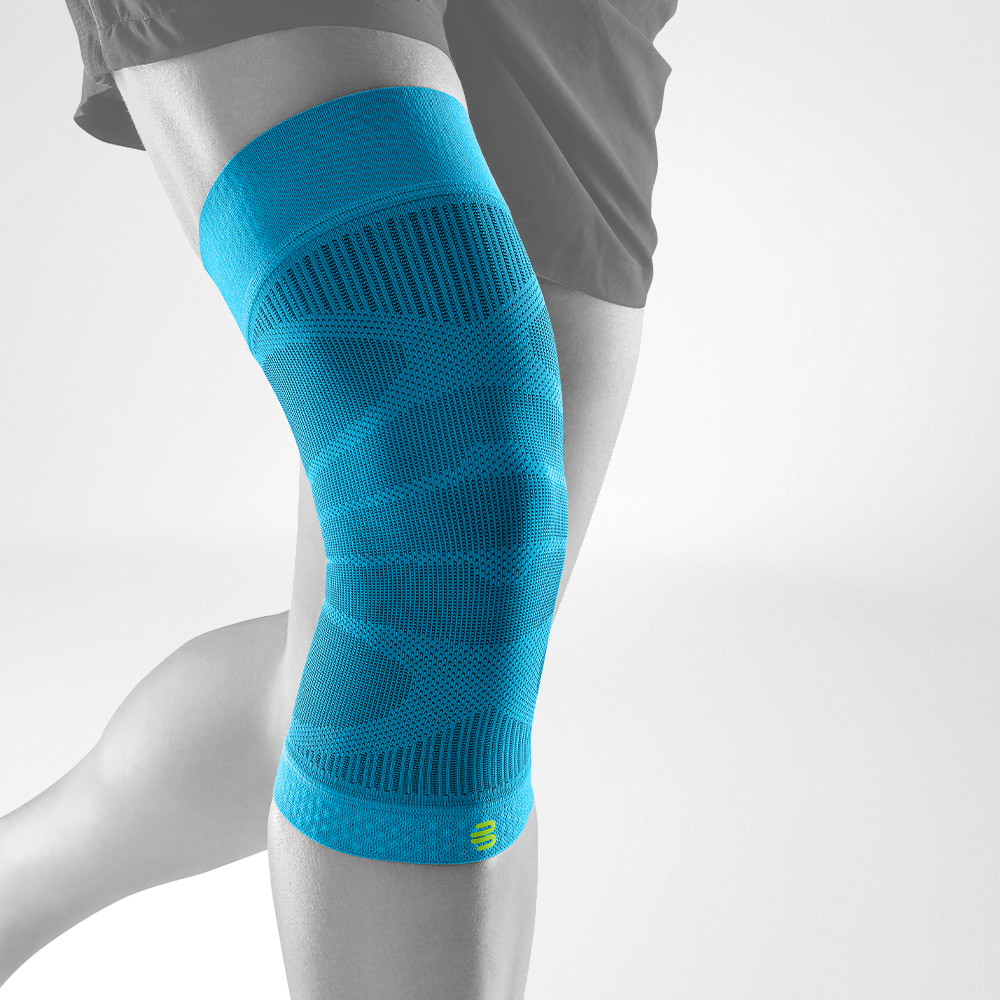 Compression Sleeve for Support and Recovery Person wearing a teal blue knee compression sleeve for support and recovery.