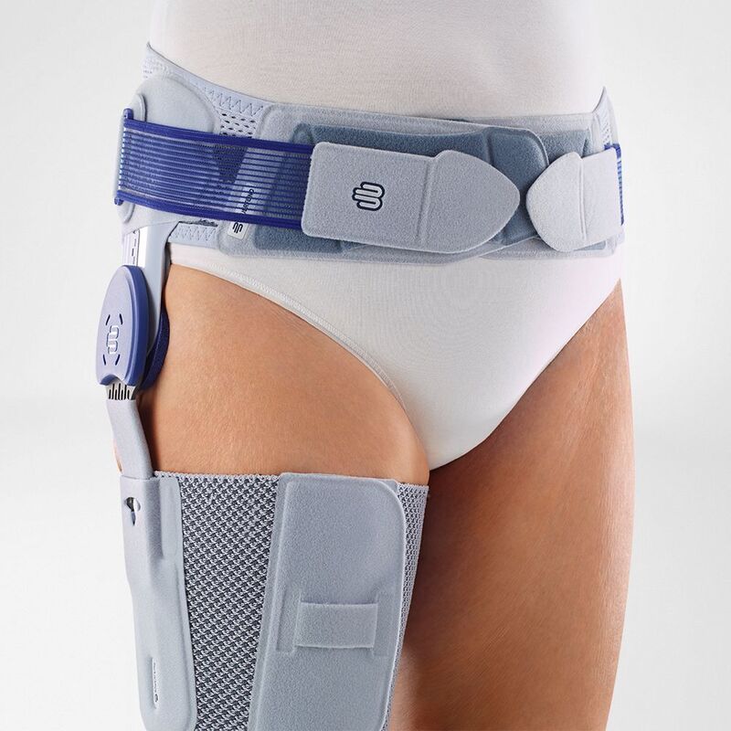 Close-up of a modern hip brace fitted on a person, showcasing the adjustable straps and stabilizing structure for orthopedic support.