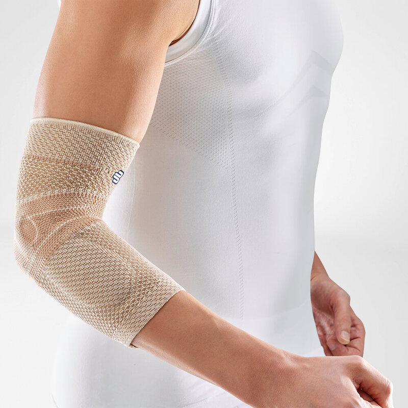 Close-up image of a person wearing Bauerfeind's beige EpiTrain elbow brace.