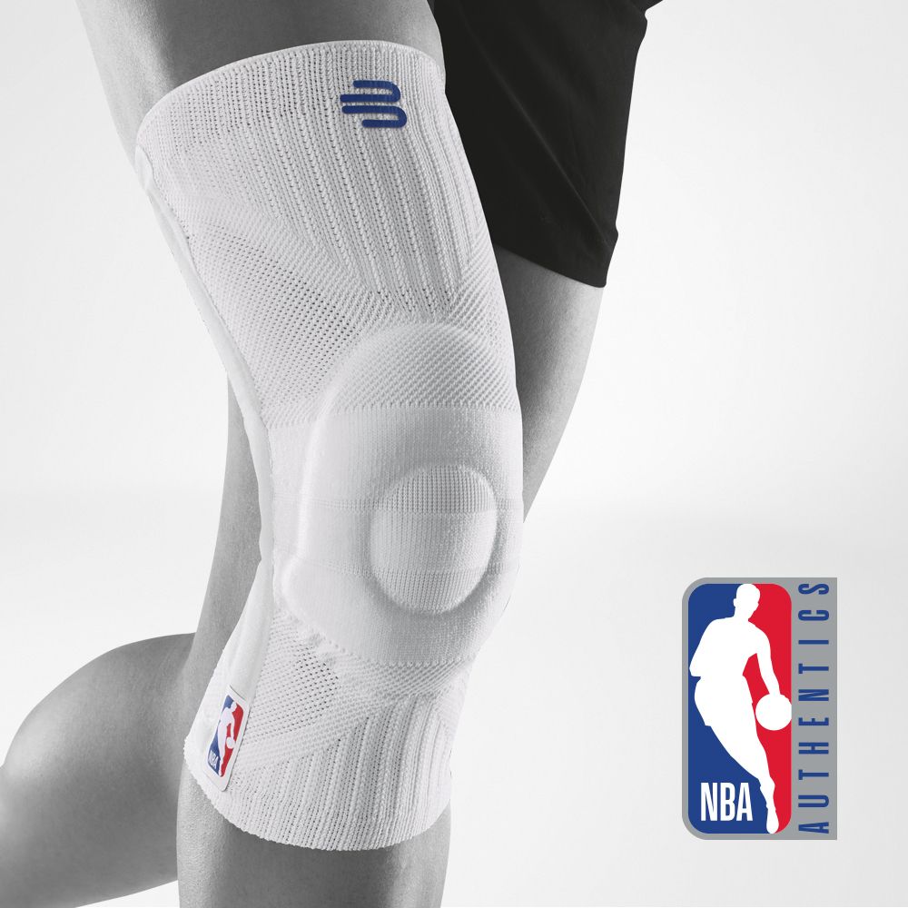 Black knee brace for athletic support with NBA logo. Close-up of a person wearing a black knee brace with an NBA logo for support during sports activities.