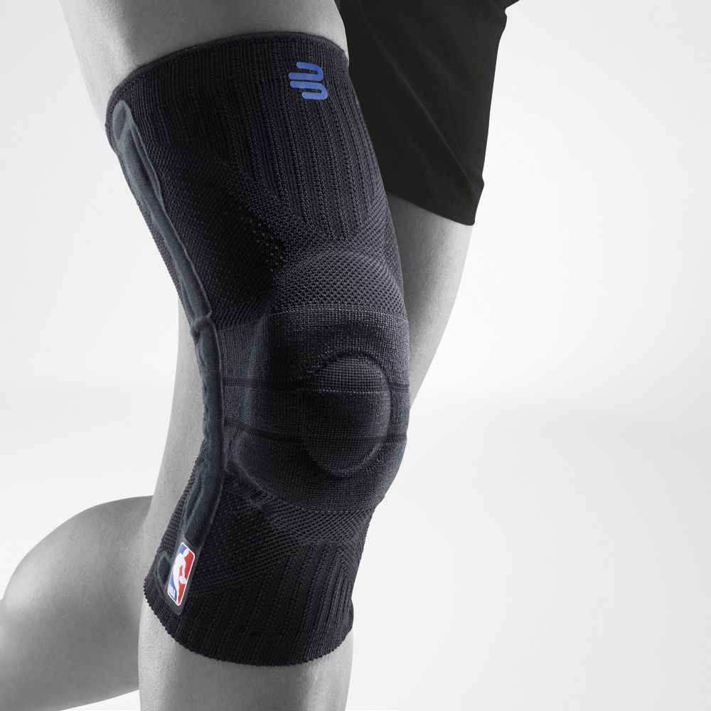 Close-up of person wearing a white knee brace with NBA logo