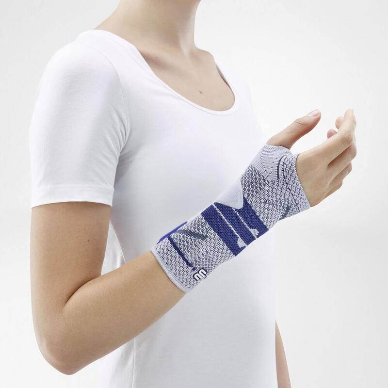 ManuTrain (Titan) Without Two-Part Strap System Image of the side of Bauerfeind's ManuTrain wrist brace while being worn by a person in front of a gray background.