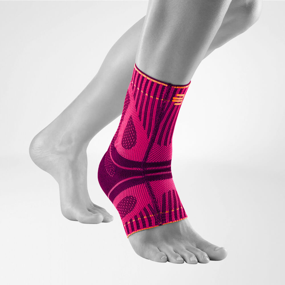 Pink achilles brace on foot and lower leg for support and injury prevention