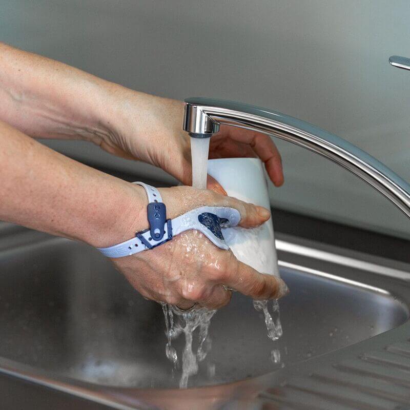 Washing Hands While Wearing the RhizoLoc OA Image of a person washing their hands with soap while wearing Bauerfeind's RhizoLoc OA arthritis thumb brace.