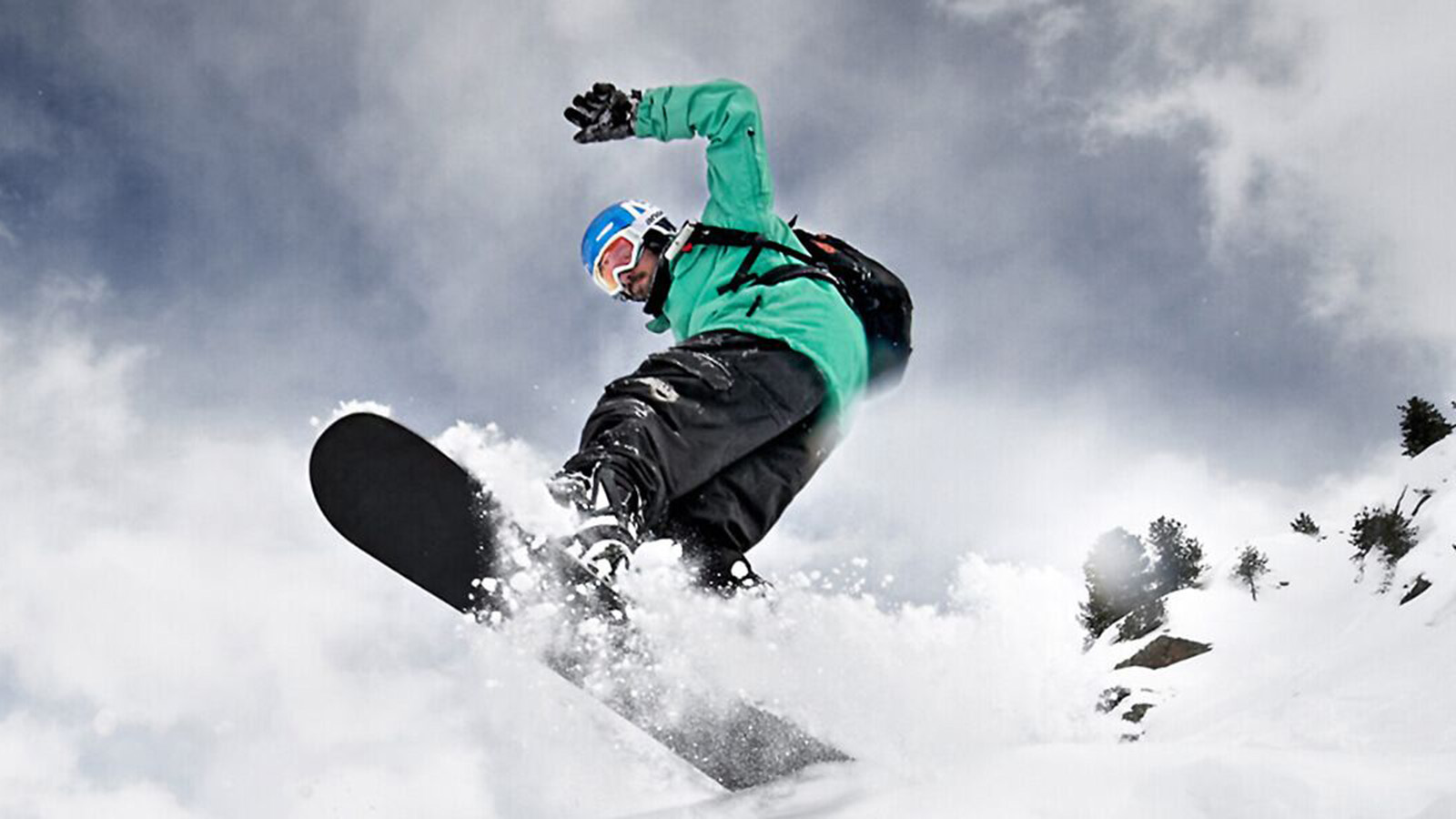 Woman skiing down a mountain slope wearing full ski gear and the Sports Back Support, Sports Knee Support and Ski Performance Compression Socks. Woman skiing down a mountain slope wearing full ski gear and Bauerfeind's Sports Back Support, Sports Knee Support and Ski Performance Compression Socks.
