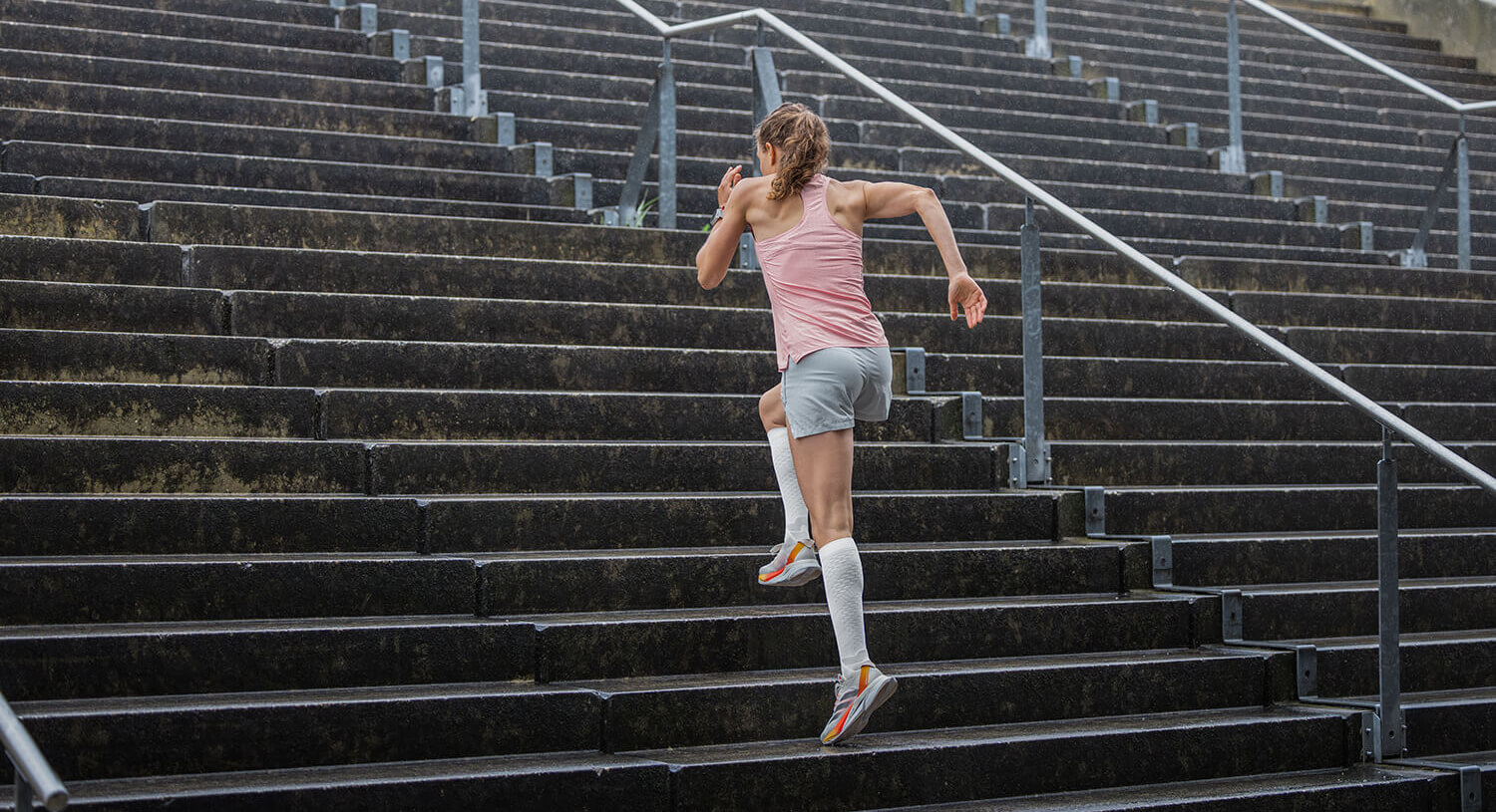 Runner wearing Run Performance Socks running up steps