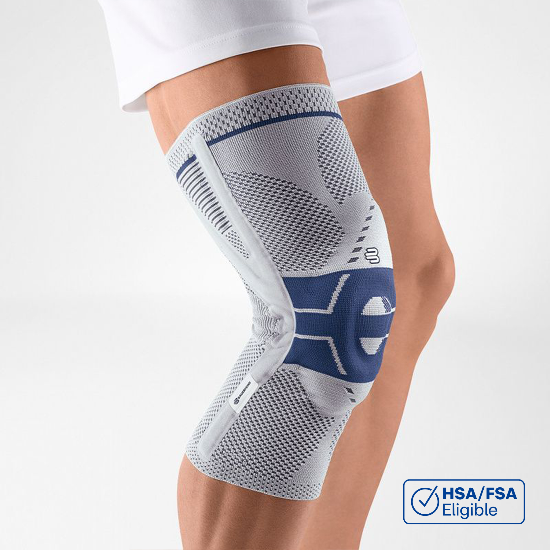 Hiking with GenuTrain P3 Patella Brace Senior couple hiking in the forest, walking on a trail surrounded by green trees and moss-covered rocks, enjoying nature together.